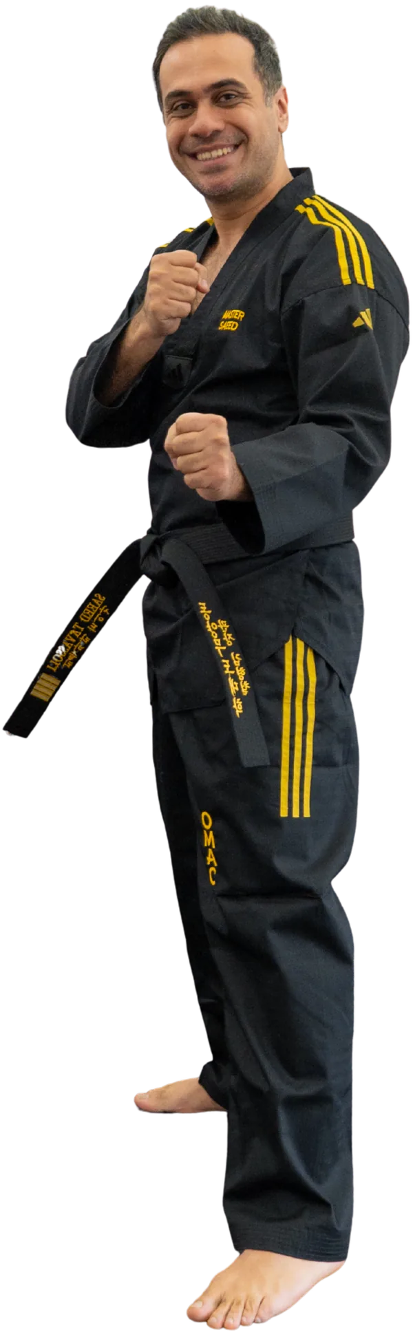 Master Saeed, Head Master, in his black OMAC uniform with fists raised