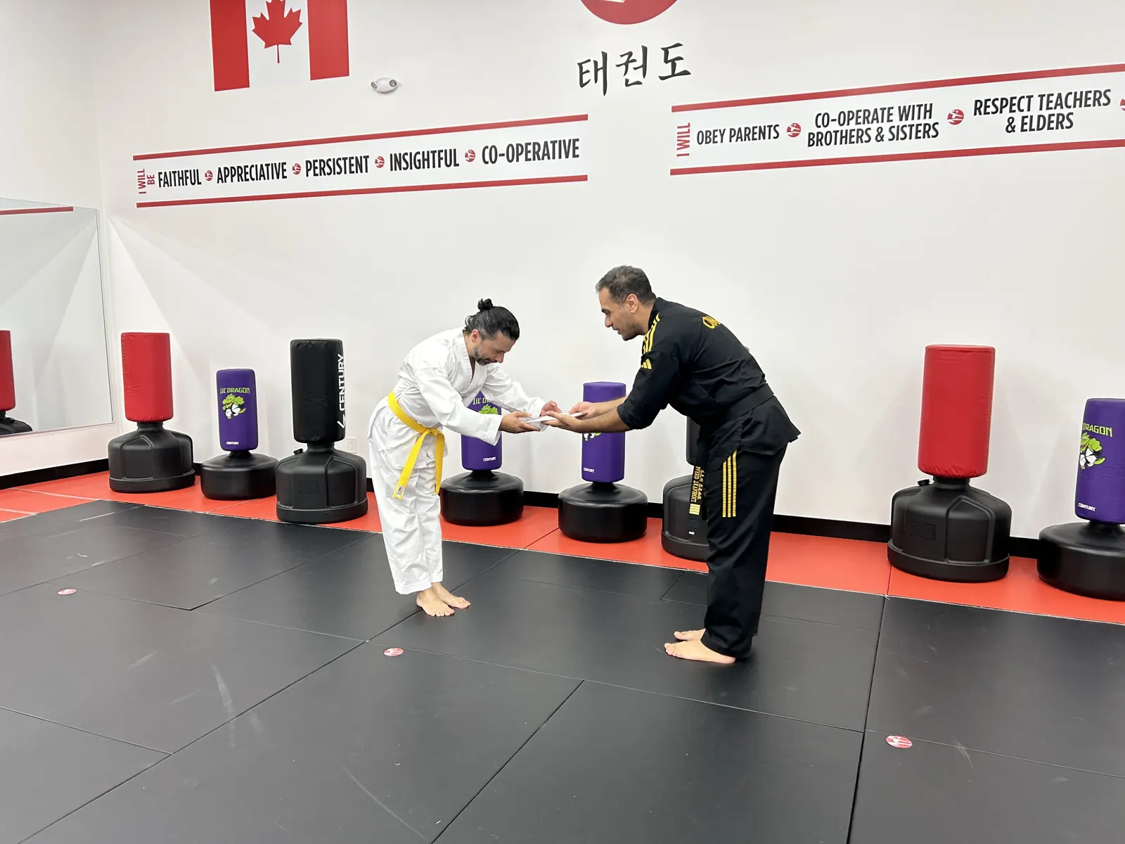 Student receiving a belt certificate